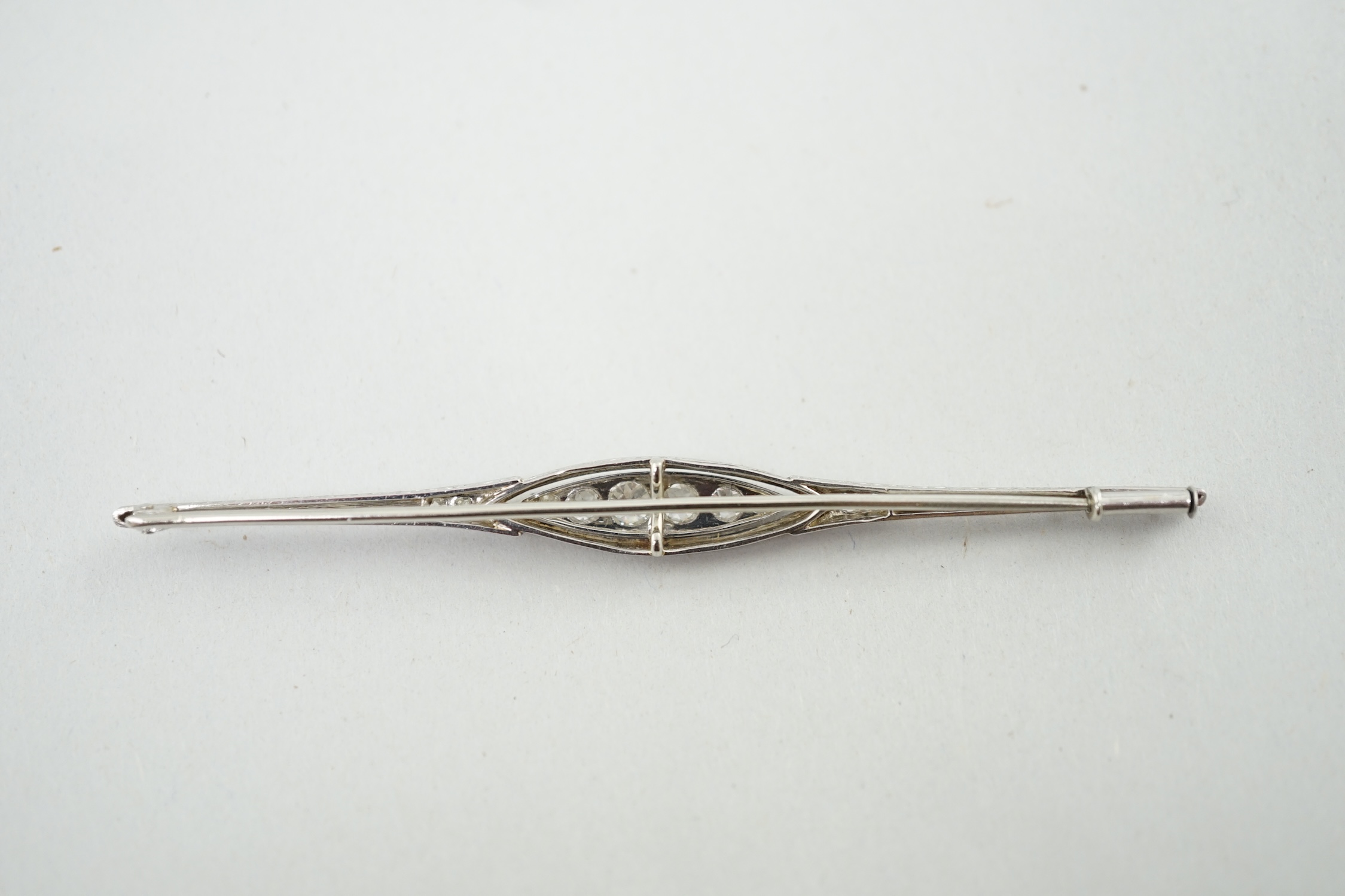 An early 20th century platinum? and diamond cluster set bar brooch